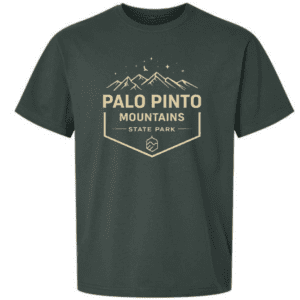 Green t-shirt featuring Palo Pinto Mountains State Park crest design with mountain peaks and stars