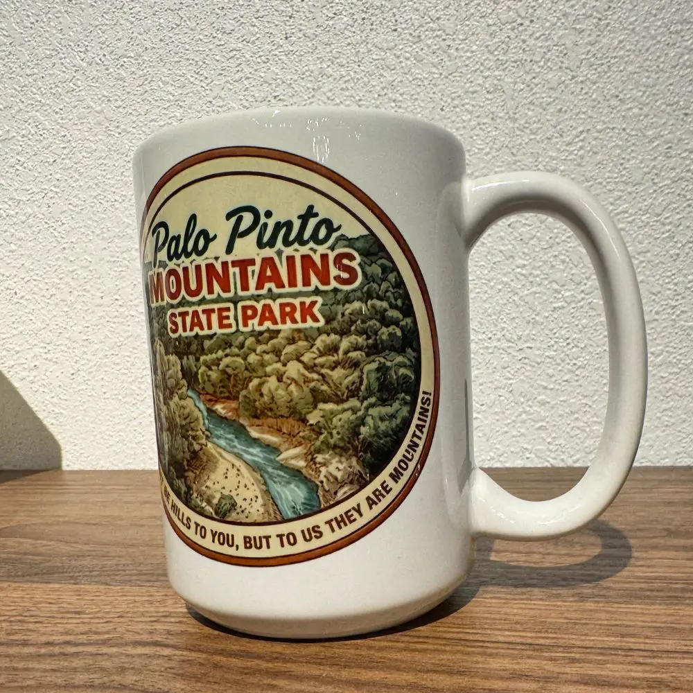 15oz ceramic mug with scenic Palo Pinto Mountains State Park design and “They might be hills” quote