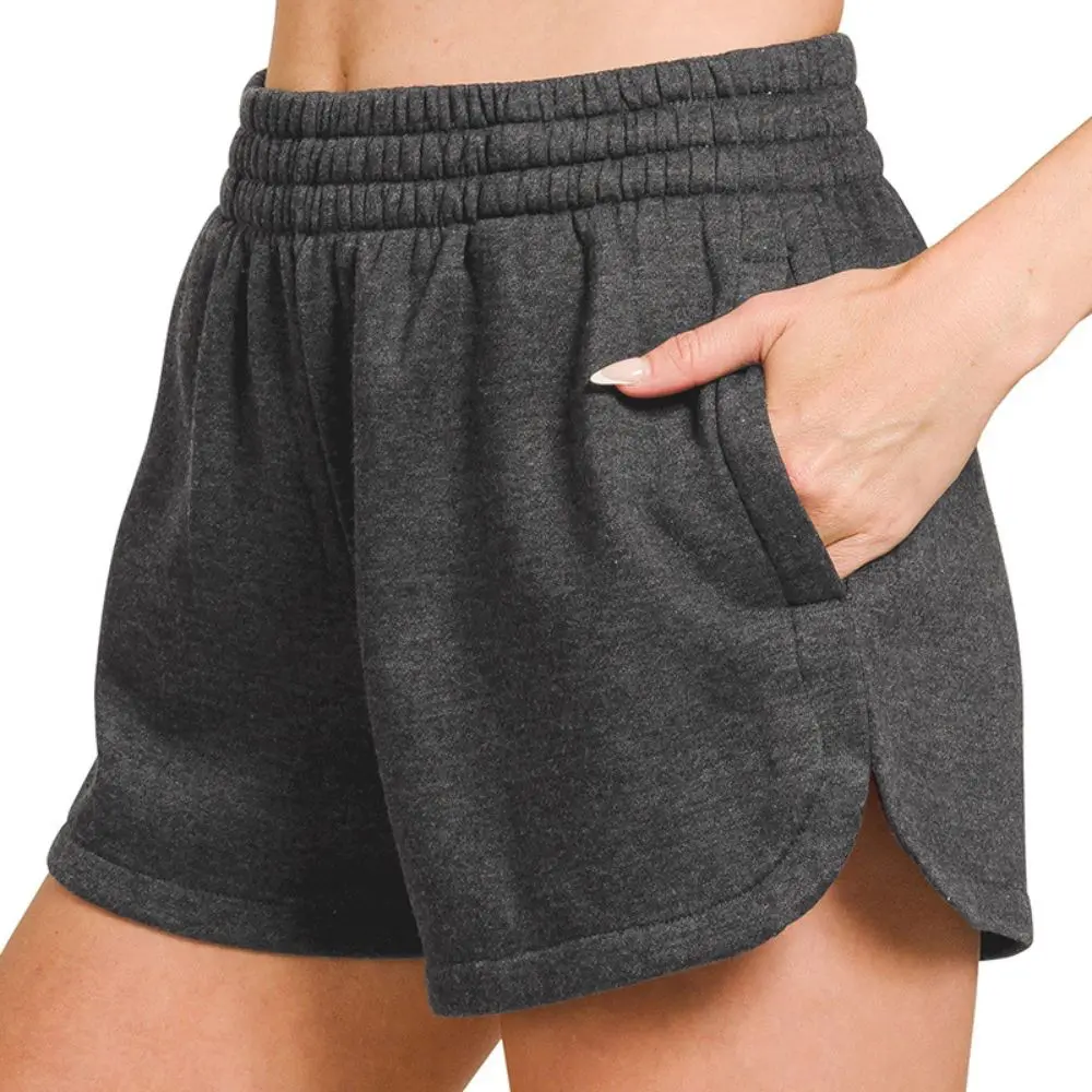 Model wearing black acid washed elastic waistband shorts with side pockets