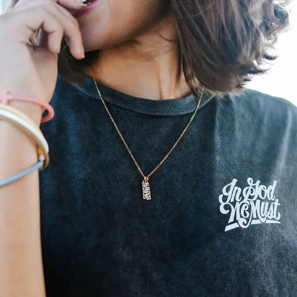 Woman wearing Jesus Saves Christian necklace