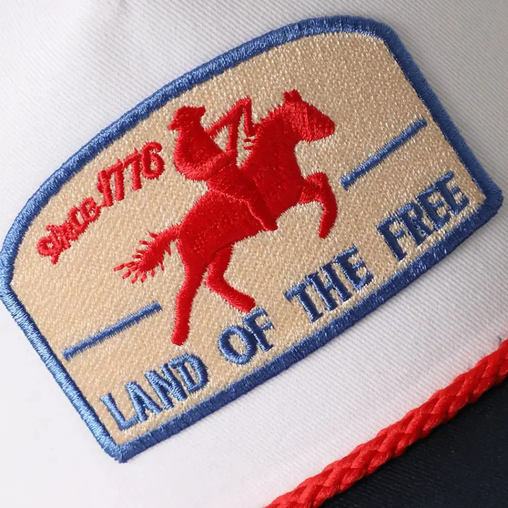 Close up of Land Of The Free embroidered patch rope trucker hat