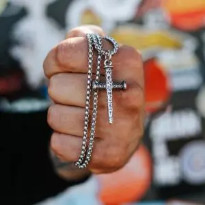 Close-up of stainless steel nail cross necklace pendant