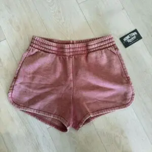 Rose acid washed elastic waistband shorts with side pockets in a soft pink vintage wash