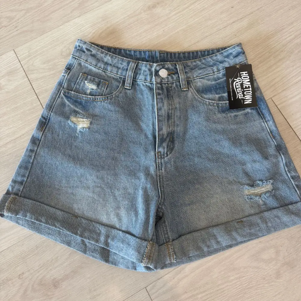 Women's high waist light wash distressed denim shorts with rolled hem