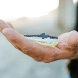 Hand holding Coconut silicone bracelet set by In God We Must