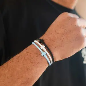 Close up of Heaven silicone cross bracelets by In God We Must