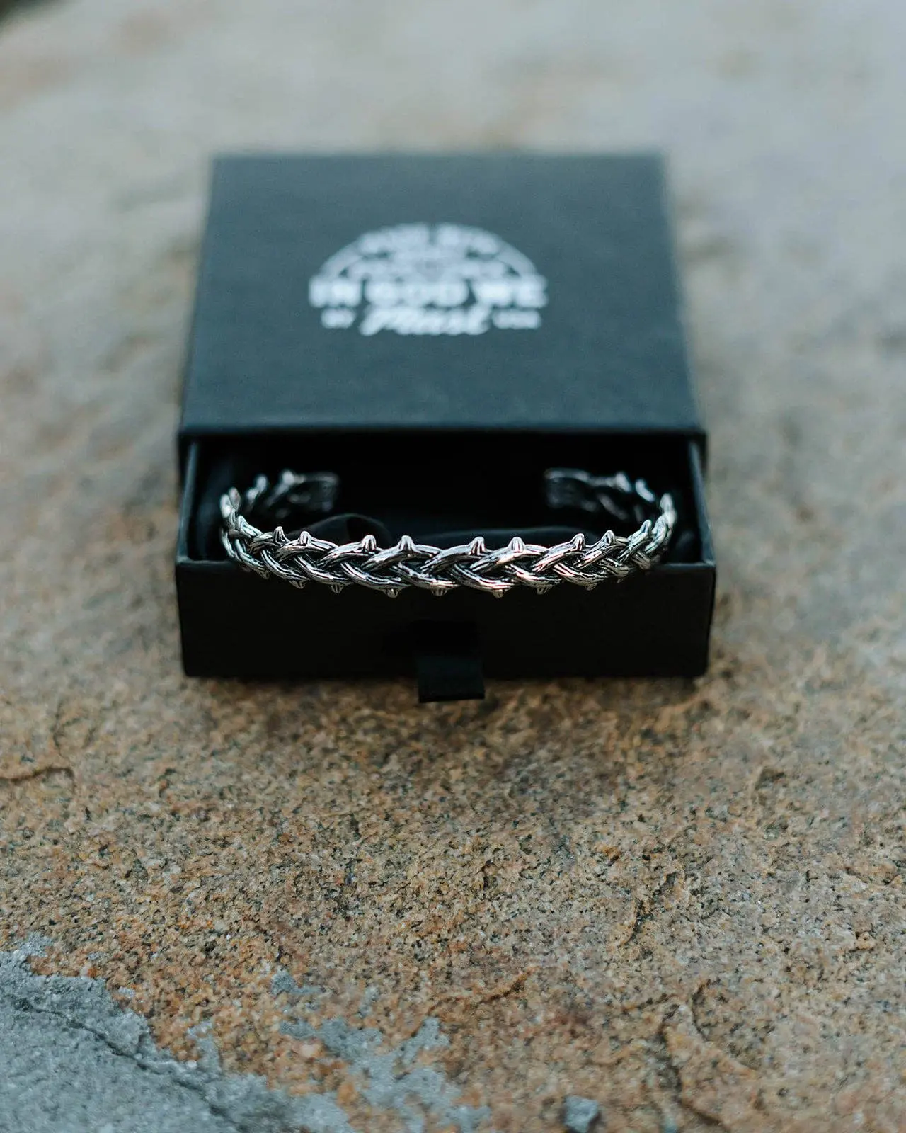 Stainless steel thorn bracelet inside black jewelry box