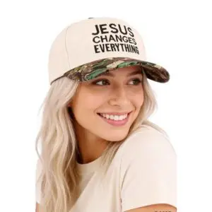 Woman wearing cream and camouflage hat with Jesus Changes Everything embroidered on the front.
