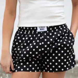 Women's Lulu Mac black boxer lounge shorts featuring a white polka dot pattern and elastic waistband.