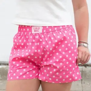 Women's Lulu Mac pink boxer lounge shorts featuring a light pink polka dot pattern and elastic waistband.