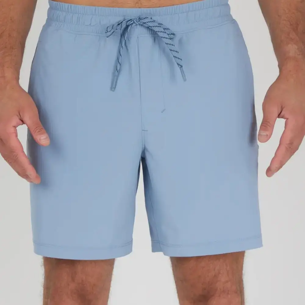Man wearing Rain Washed woven vortex performance shorts with adjustable waistband.