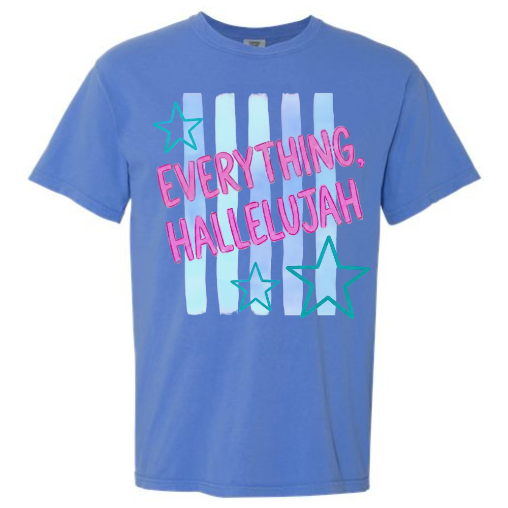Blue t-shirt featuring Everything Hallelujah graphic with pink lettering, teal stars, and colorful vertical stripes.
