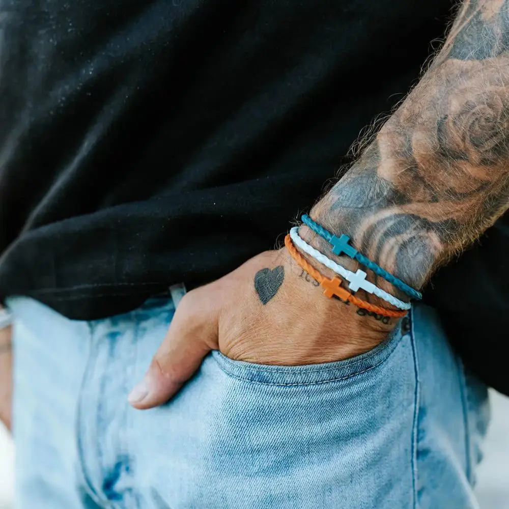 Daybreak silicone cross bracelets worn on wrist by In God We Must