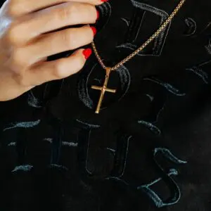 Close-up of gold stainless steel cross necklace with box chain by In God We Must