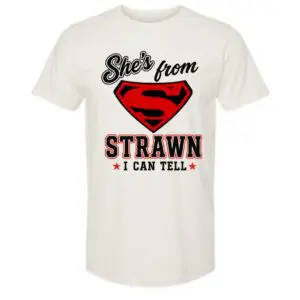 White 100% cotton She's From Strawn I Can Tell T-shirt featuring a bold red and black hometown graphic