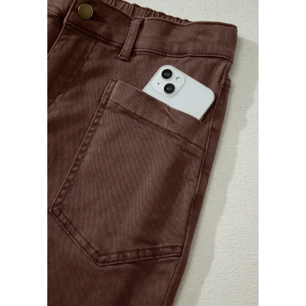 Front patch pocket detail on brown barrel leg jeans