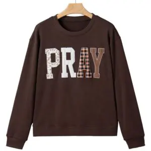 Brown PRAY sweatshirt with neutral patchwork lettering
