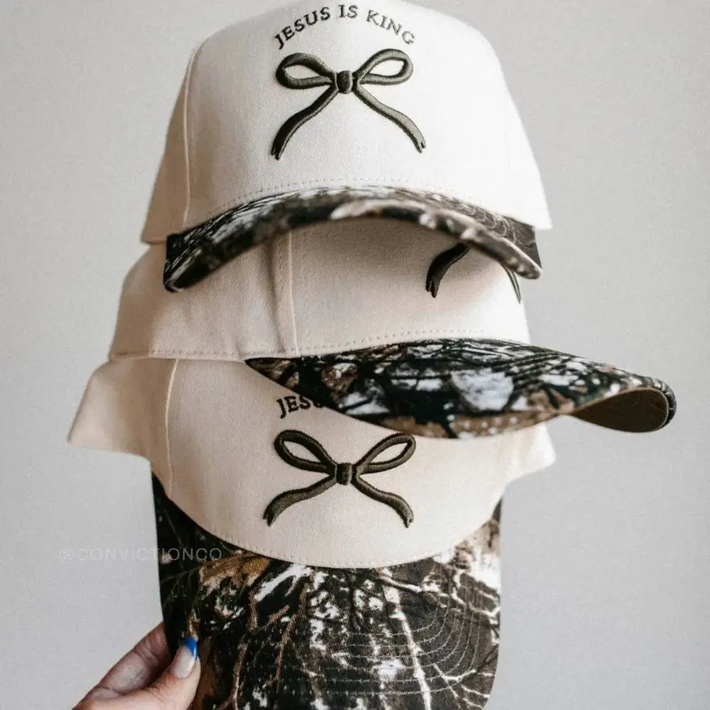 Jesus Is King Bow Camo Hats by Conviction Co. stacked together