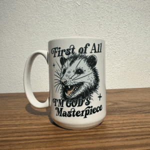Ceramic mug with illustration of a possum and text that reads “First of All, I’m God’s Masterpiece”