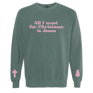 Green Comfort Colors sweatshirt with pink text that reads “All I Want For Christmas Is Jesus” and sleeve graphics