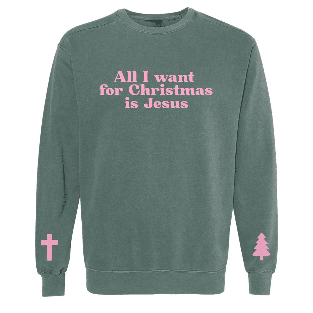 Green Comfort Colors sweatshirt with pink text that reads “All I Want For Christmas Is Jesus” and sleeve graphics