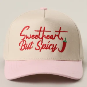 Sweetheart But Spicy embroidered trucker hat with cream crown, pink brim, and chili pepper detail
