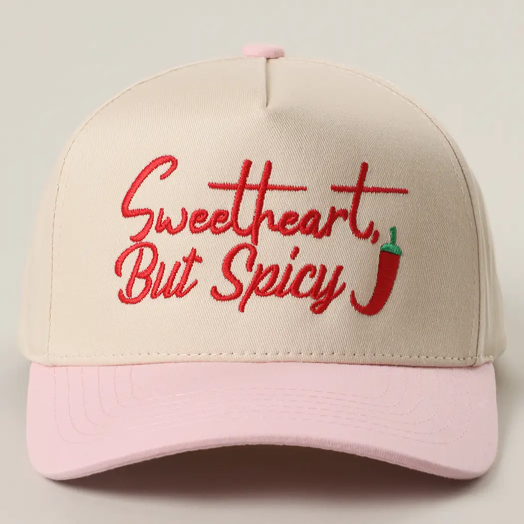 Sweetheart But Spicy embroidered trucker hat with cream crown, pink brim, and chili pepper detail